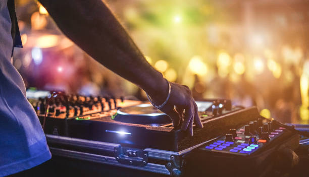 istockphoto-1141427484-612x612 Dj mixing outdoor at beach party festival with crowd of people in background - Summer nightlife view of disco club outside - Soft focus on hand - Fun ,youth,entertainment and fest concept